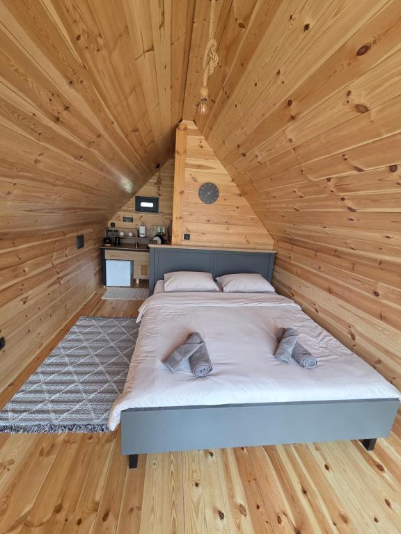 a bed in a room with a wooden ceiling at Eagle's View Cabin in Plav