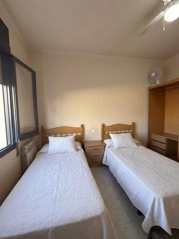 two beds in a room with at Los Hermanos in Viladecáns