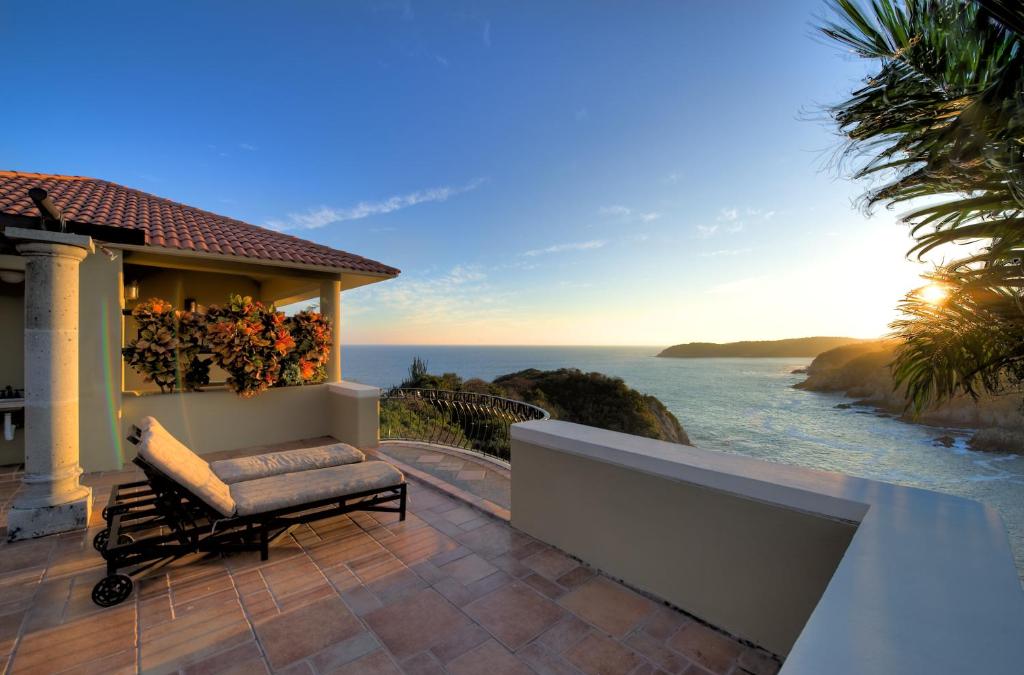 a balcony of a house with a view of the ocean at Las Palmas Oceanfront Villas and Casitas in Santa Cruz Huatulco