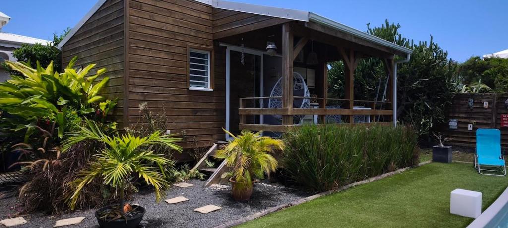 a tiny house with a porch and a deck at Villa Rosa Karibella in Saint-François