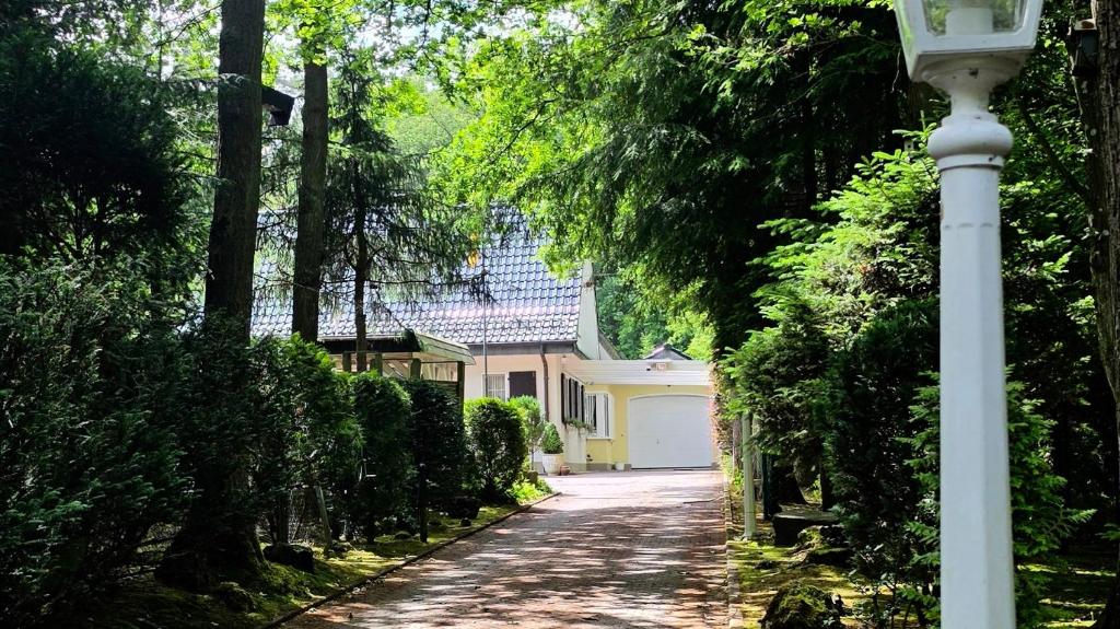 a white street light next to a house at Villa Albert in Euskirchen