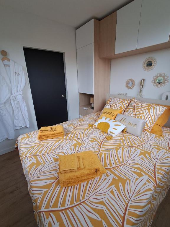 a bedroom with two beds with towels on them at Studio Cotentin Evas'yon in Feugères