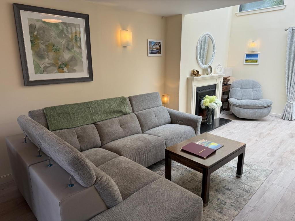 a living room with a couch and a table at Large four bedroom town centre house in Killarney