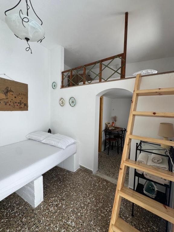 a bedroom with a bunk bed and a ladder at Nostalgia Traditional Home in Skiros