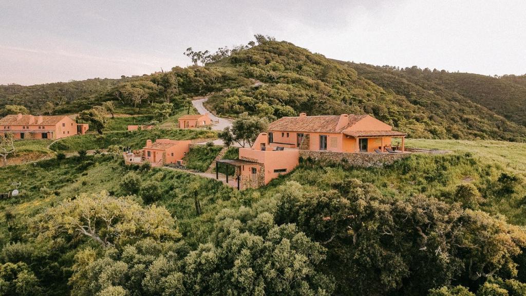 a house on the side of a hill at Vale Palheiro Earth Resort in Aljezur