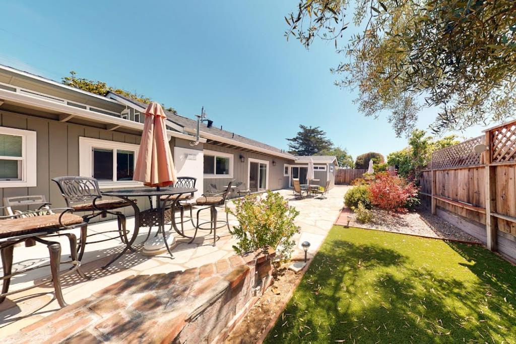 a patio with a table and chairs and an umbrella at Portola Oasis - Permit DRO-STR-18 in Monterey