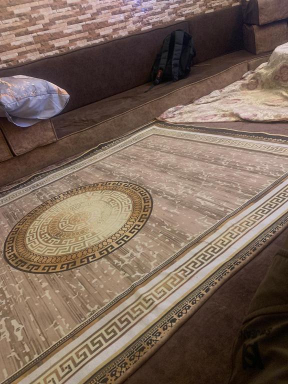 a rug on the floor in front of a couch at Moon in Amman