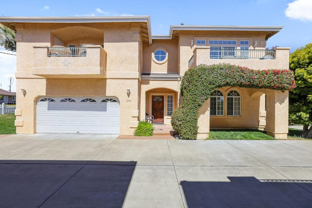 a large house with a garage in front of it at Santo Tomas Getaway in Grover Beach