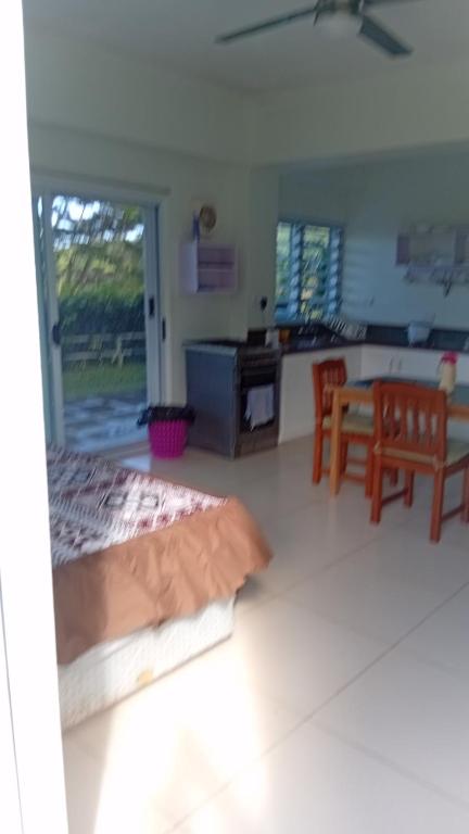 a bedroom with a bed and a table and chairs at Sunview in Savusavu
