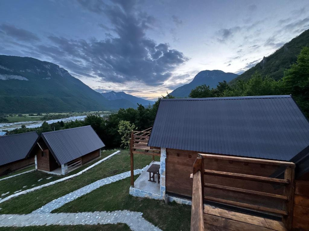 a view of a barn with mountains in the background at Lagano Mountain Retreat - Via Ferrata & Restaurant in Gusinje