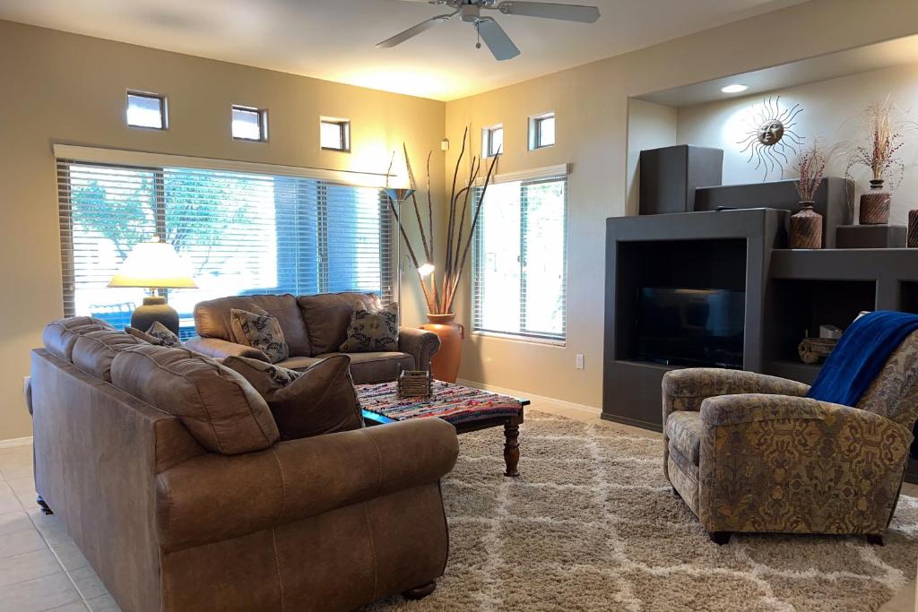 a living room with two couches and a tv at Vistoso Resort Casita #163 in Oro Valley