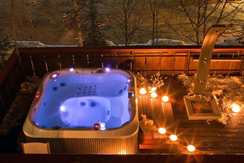 a blue tub sitting in the yard with lights at Hotel Regina in San Martino di Castrozza