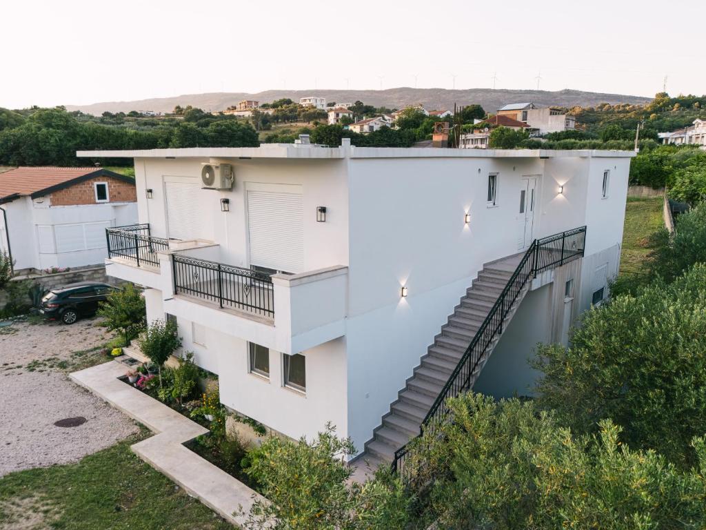 an aerial view of a white building with stairs at Dëshira Apartments in Ulcinj