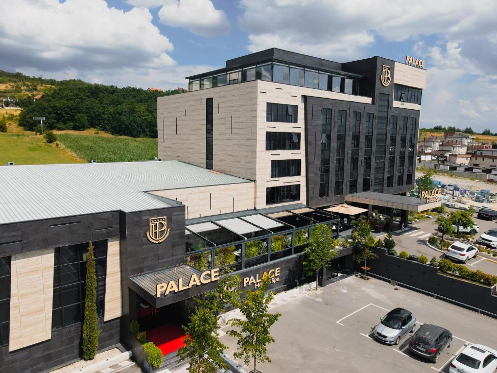 an aerial view of a palace hotel with a parking lot at Palace Hotel & SPA in Mitrovica