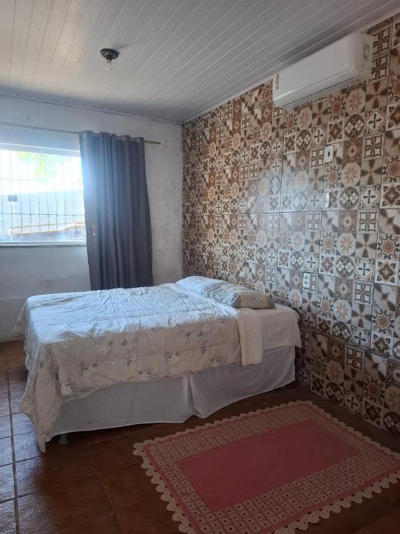 a bedroom with a large bed in a room at Suíte Centro Histórico in São Luís