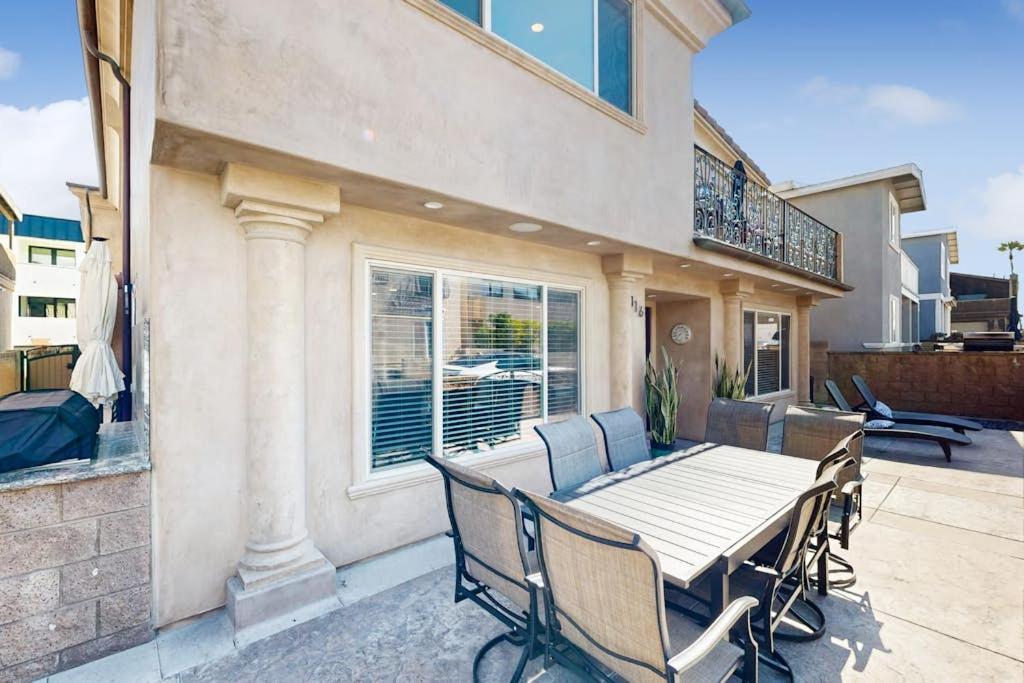 a patio with a wooden table and chairs at Palm Tree Getaway in Newport Beach