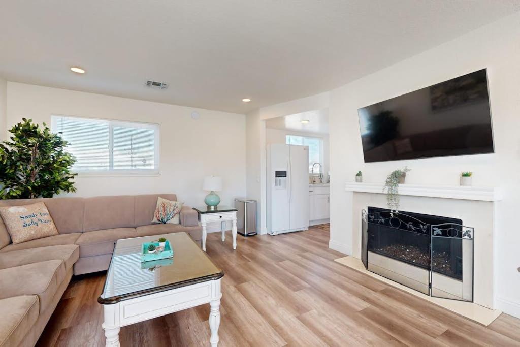 a living room with a couch and a fireplace at Sunny Days in Newport Beach