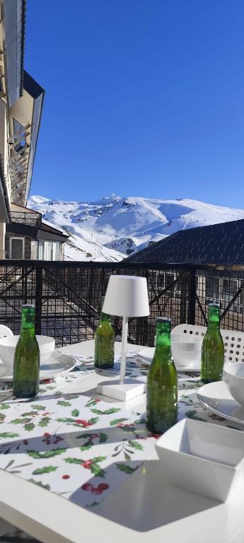 a table with green bottles sitting on top of it at Snow Dreams in Sierra Nevada