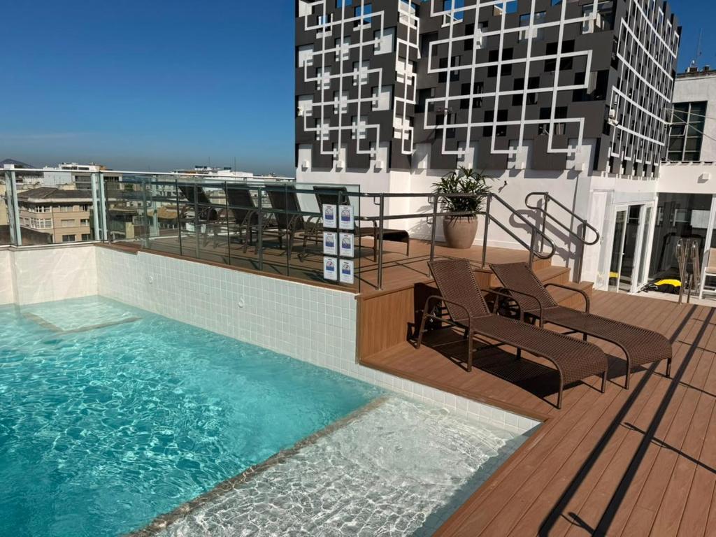 a balcony with a swimming pool on top of a building at Rio Design Copacabana Hotel in Rio de Janeiro