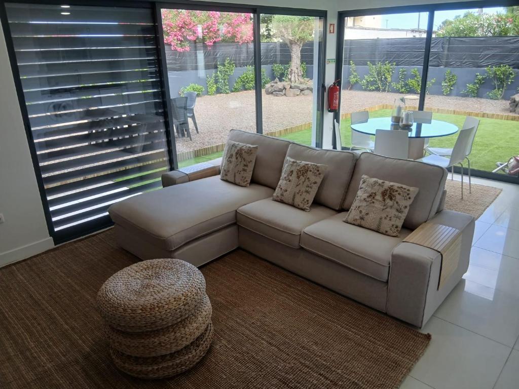 a living room with a couch and a table at Casa das 3 Oliveiras in Porto Santo