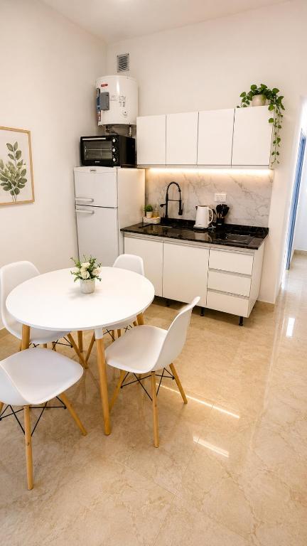 a kitchen with a table and two chairs and a table and a counter at San bernardo relax in San Bernardo