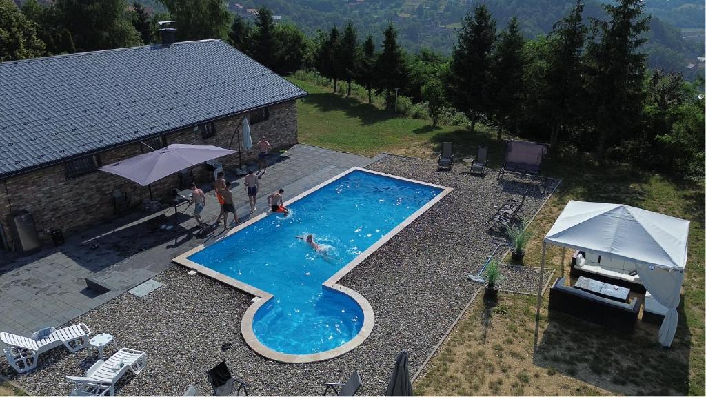 an overhead view of a swimming pool with people in it at Villa Noir Sarajevo in Sarajevo