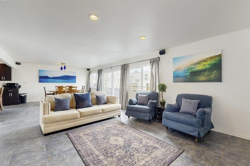 a living room with a couch and two chairs at Upper Level Beach Retreat in Newport Beach