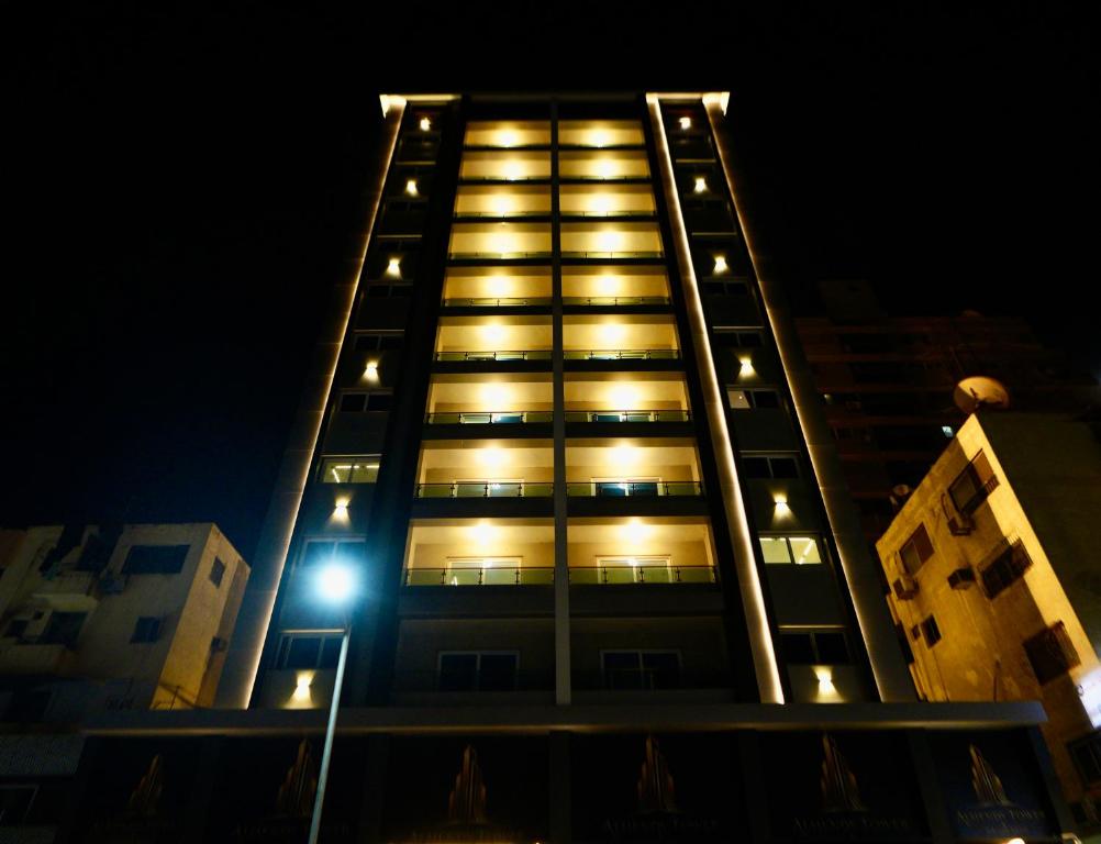 a tall building with a street light in front of it at برج الهندي in Cairo