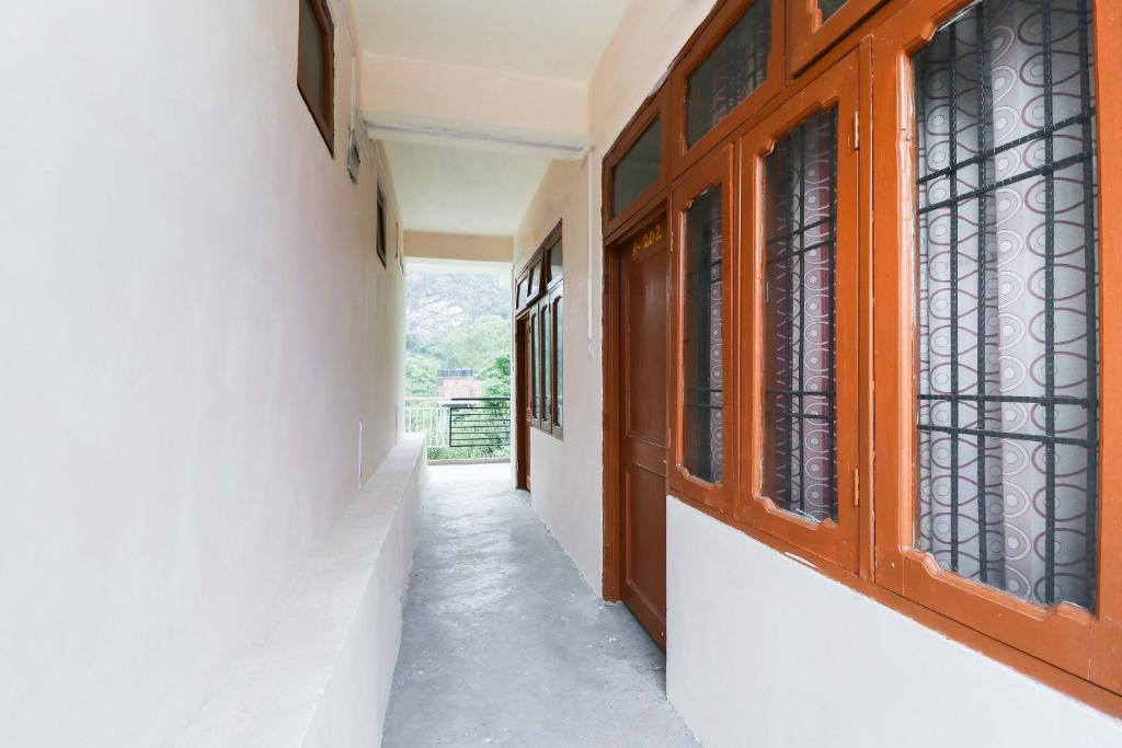 a corridor of a house with a window at Hotel O Dp Bar in Rāmpur