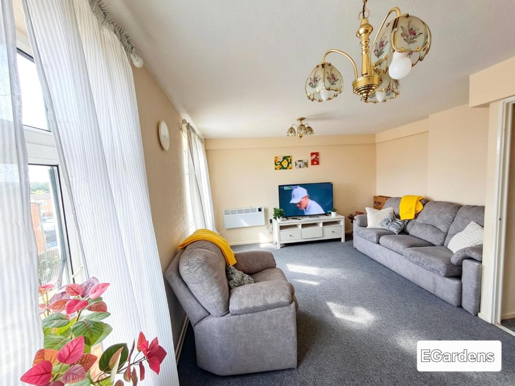 a living room with two couches and a tv at E Gardens Apartment in Nottingham