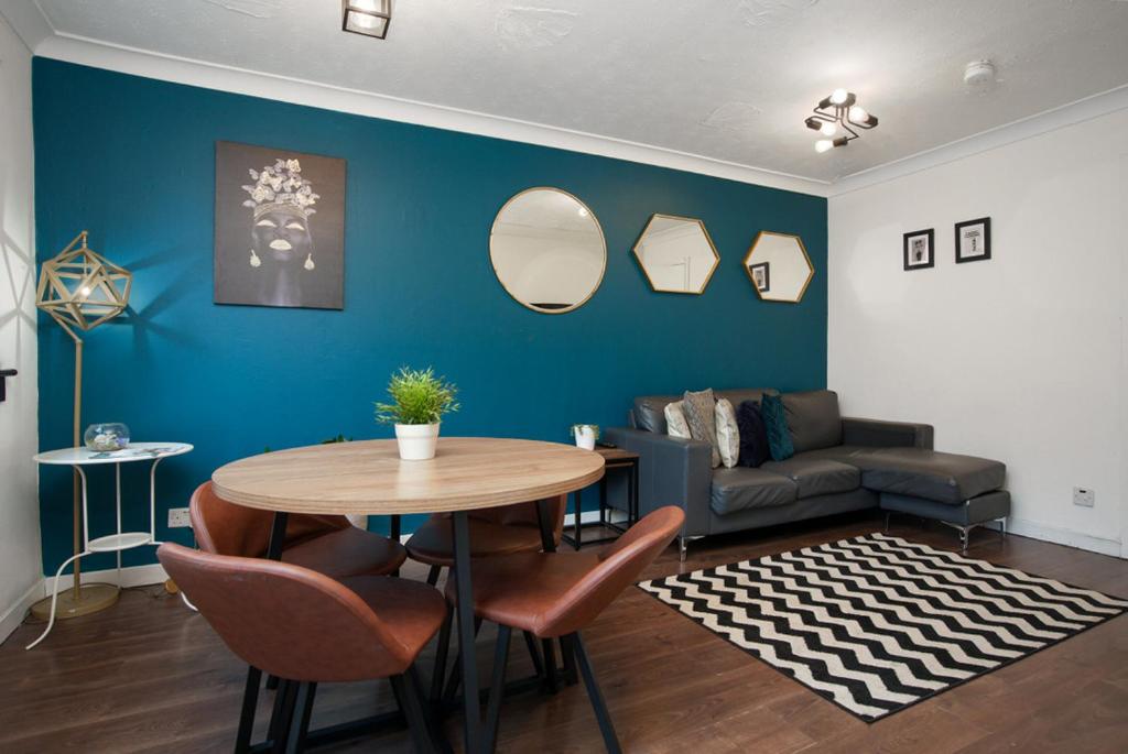 a living room with a table and a couch at BrightCentral Apartment With Parking in Glasgow