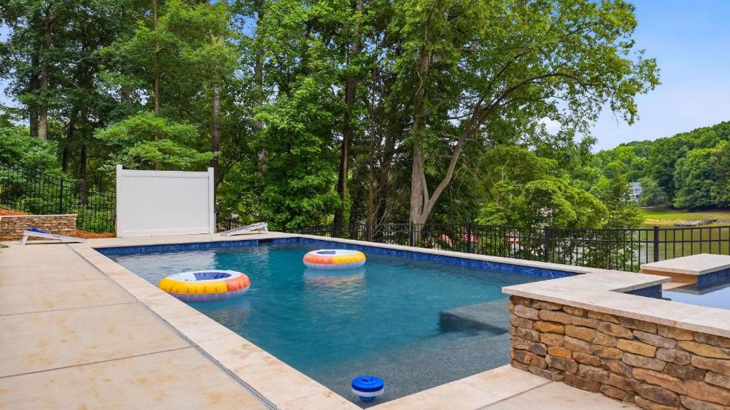 a swimming pool with two inflatable balls in the water at Poolside Paradise by AvantStay in Sherrills Ford