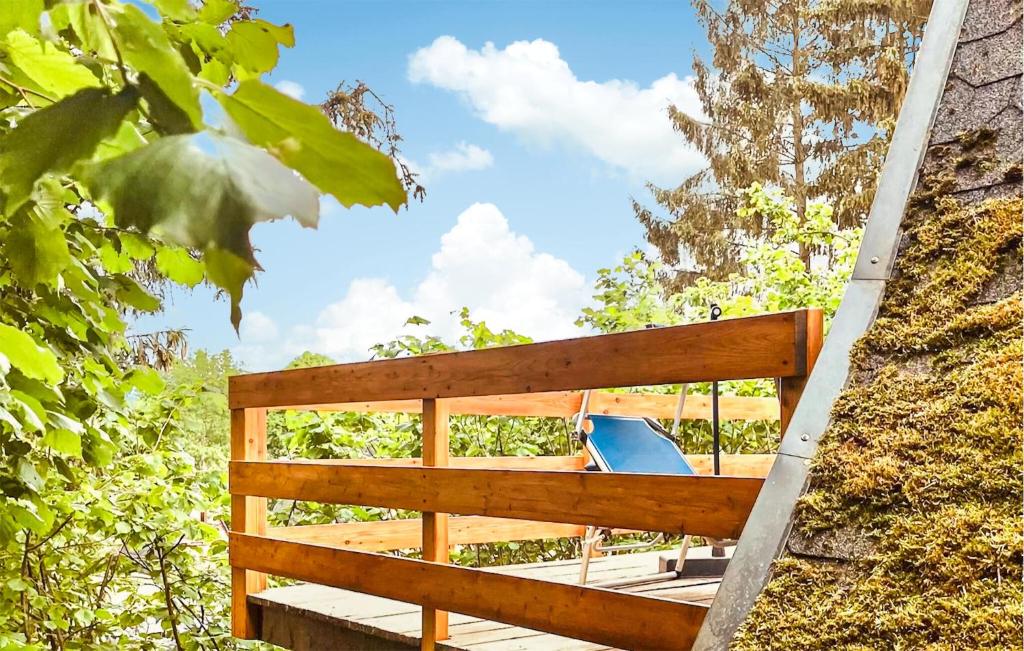 a wooden deck with a bench in the woods at 2 Bedroom Nice Home In Bad Lobenstein in Bad Lobenstein