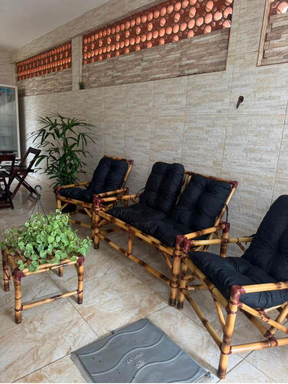 three chairs and a couch on a patio at Refúgio Beira Mar Na Praia da Tartaruga in Rio das Ostras