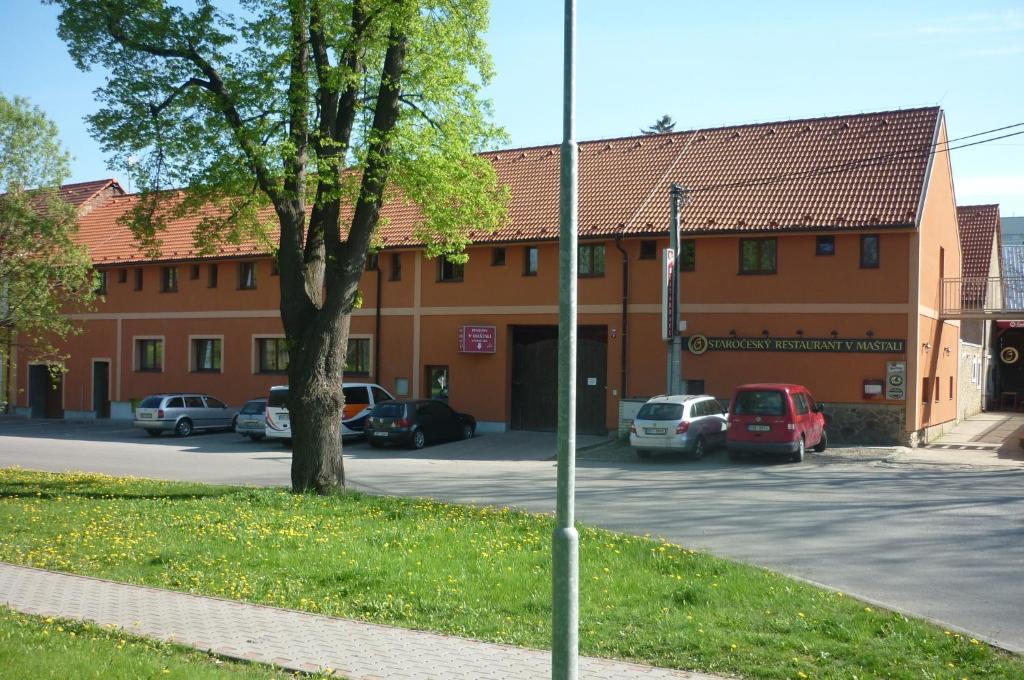 a car parked on the side of a road near a building at Penzion V Maštali in Kněževes