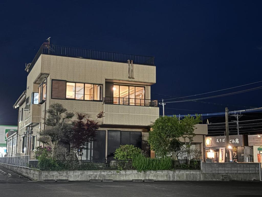 a large building with windows at night at はなれ香 in Kirishima
