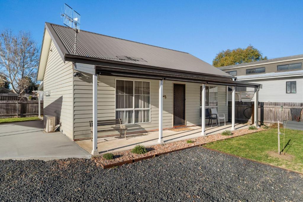 a house with a large screened in porch at 15B Bolton Street in Berridale