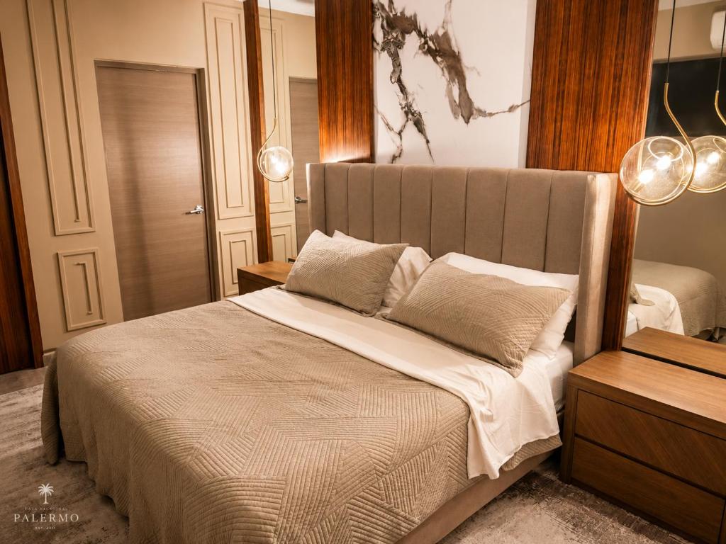 a bedroom with a large bed with two pillows at Casa Palermo con Jacuzzi in Los Mochis