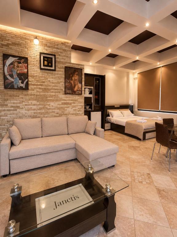 a living room with a couch and a table at Kladis Club Holidays in Skala Potamias