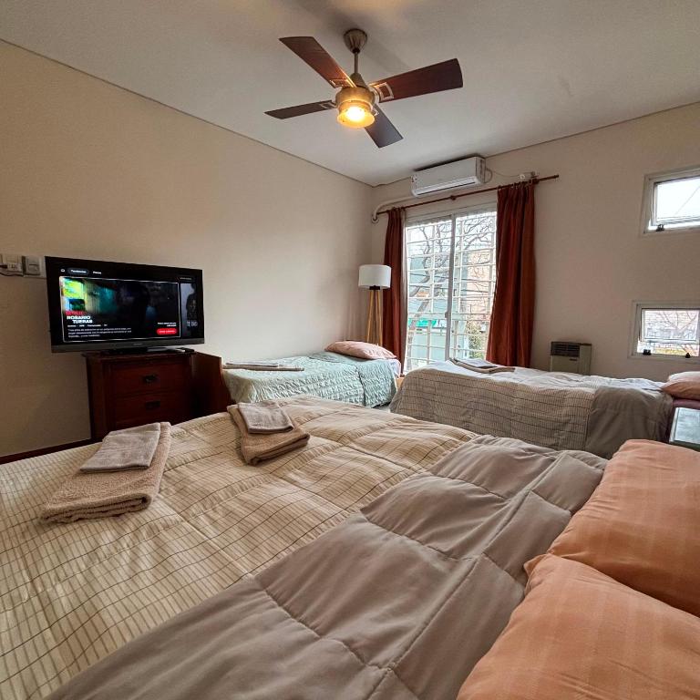 a bedroom with a bed and a ceiling fan at KAD Alojamiento in Mendoza