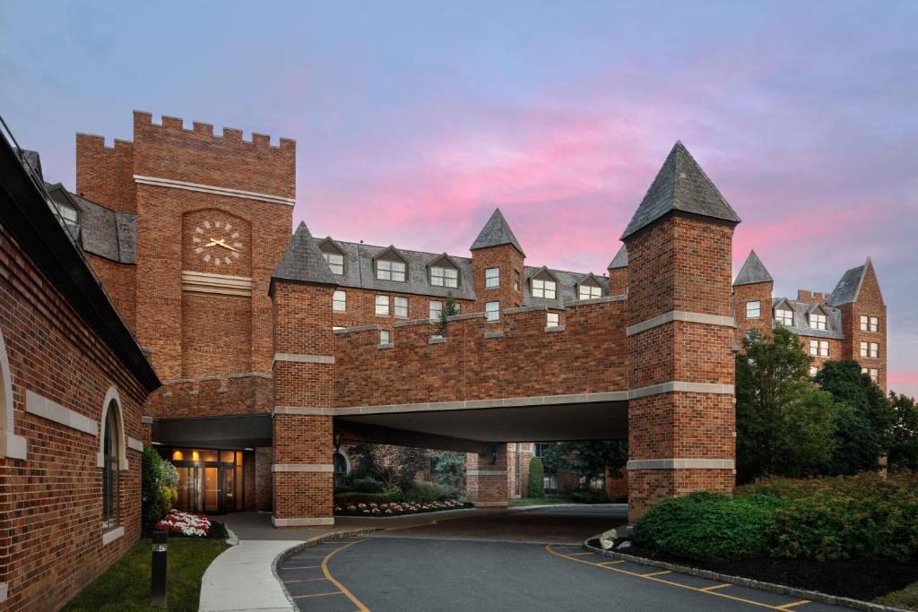 a large red brick building with a clock tower at Dolce by Wyndham Parsippany in Parsippany