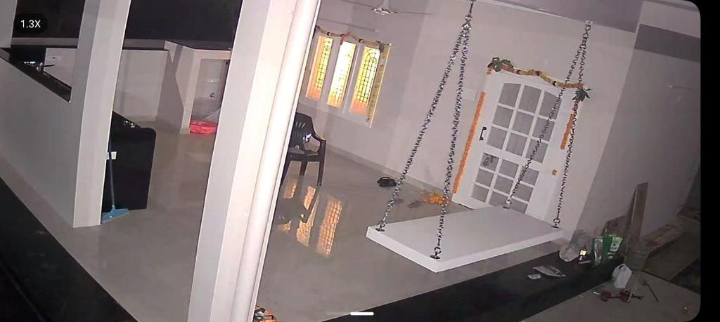 an overhead view of a living room with a swing at Relax Holiday Guest House in Kākināda