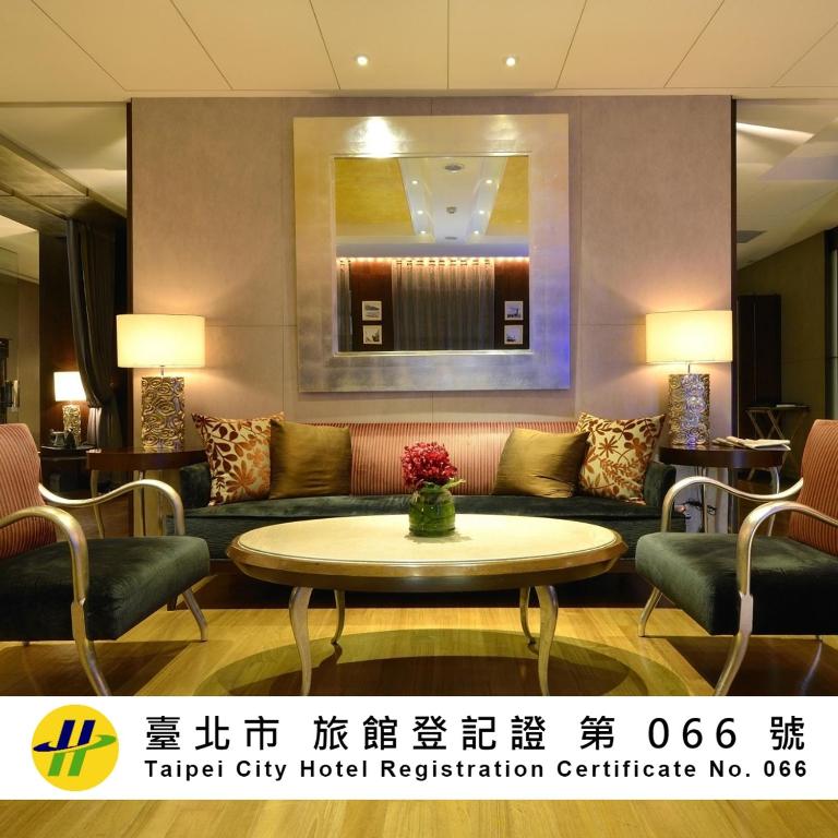 a hotel lobby with a couch and a table at Les Suites Taipei - Da An in Taipei