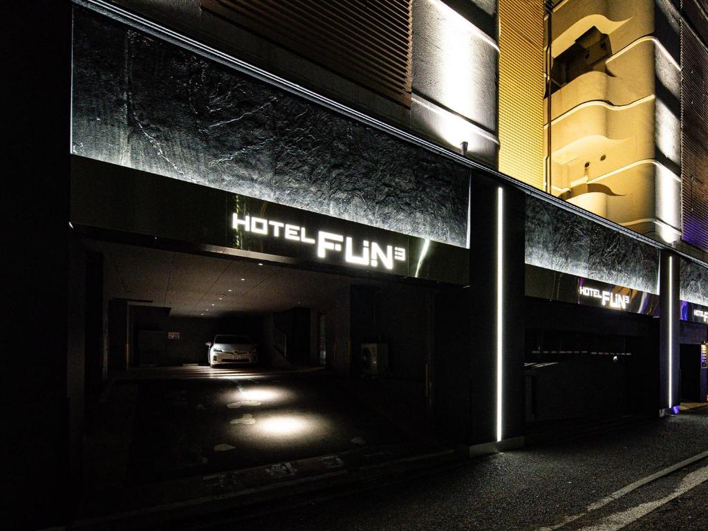 a hotel sign on the side of a building at night at FUN3 ﾌｧﾝｽﾘｰ -Adult Only- in Yokohama