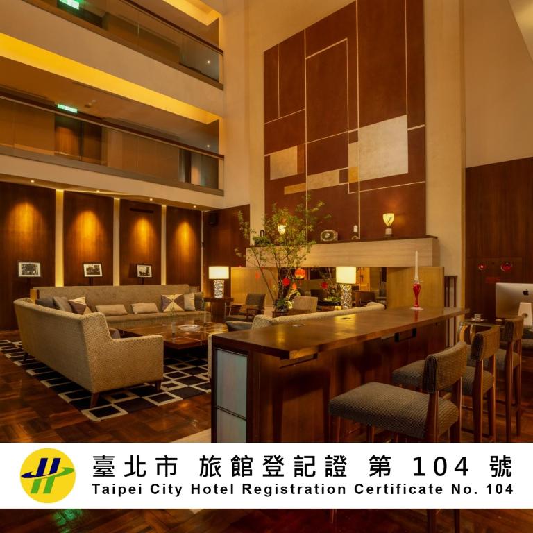 a lobby of a hotel with a table and chairs at les suites taipei ching cheng in Taipei