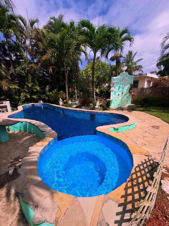 a swimming pool in a resort with a blue at CasaLoca Cabarete Studio Apartment in Cabarete