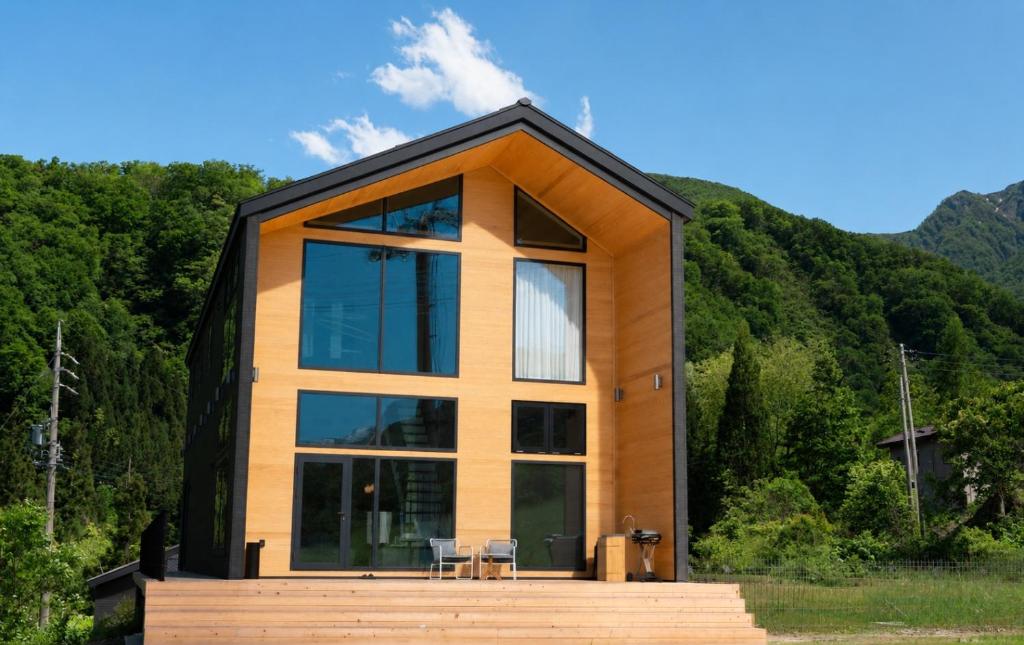 a house with a black roof and windows at THE OneThird HAKUBA Slopefront Villas in Hakuba