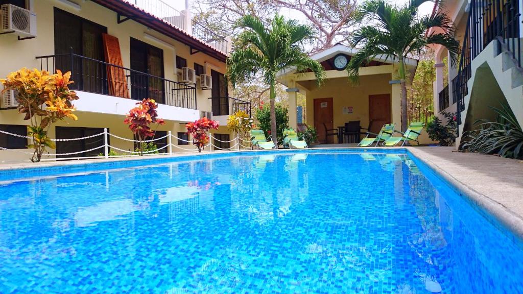 a large blue swimming pool next to a building at Vista Perfecta 2 in Coco