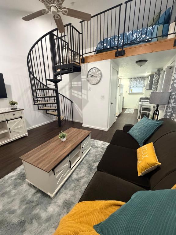 a living room with a couch and a staircase at Cozy Creek Retreat in Waterford