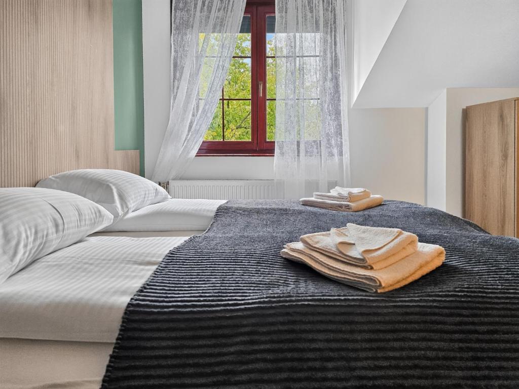 a bedroom with two beds with towels on the bed at ParkNest - Apartmani i sobe in Apatin